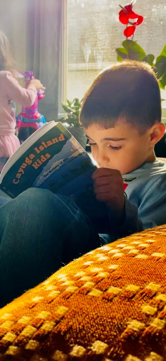 Cayuga Island Kid reading CIK